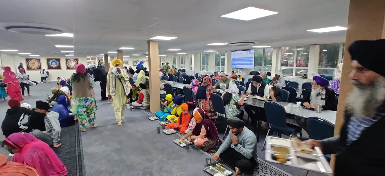 Sangat sharing Langar in the langar hall during the Golden Jubilee
