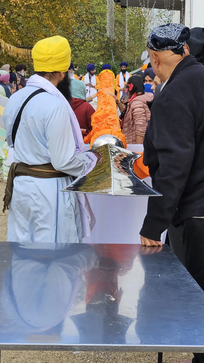 The Khanda fitted at the tip of the Nishan Sahib, now wrapped in its orange Chola Sahib